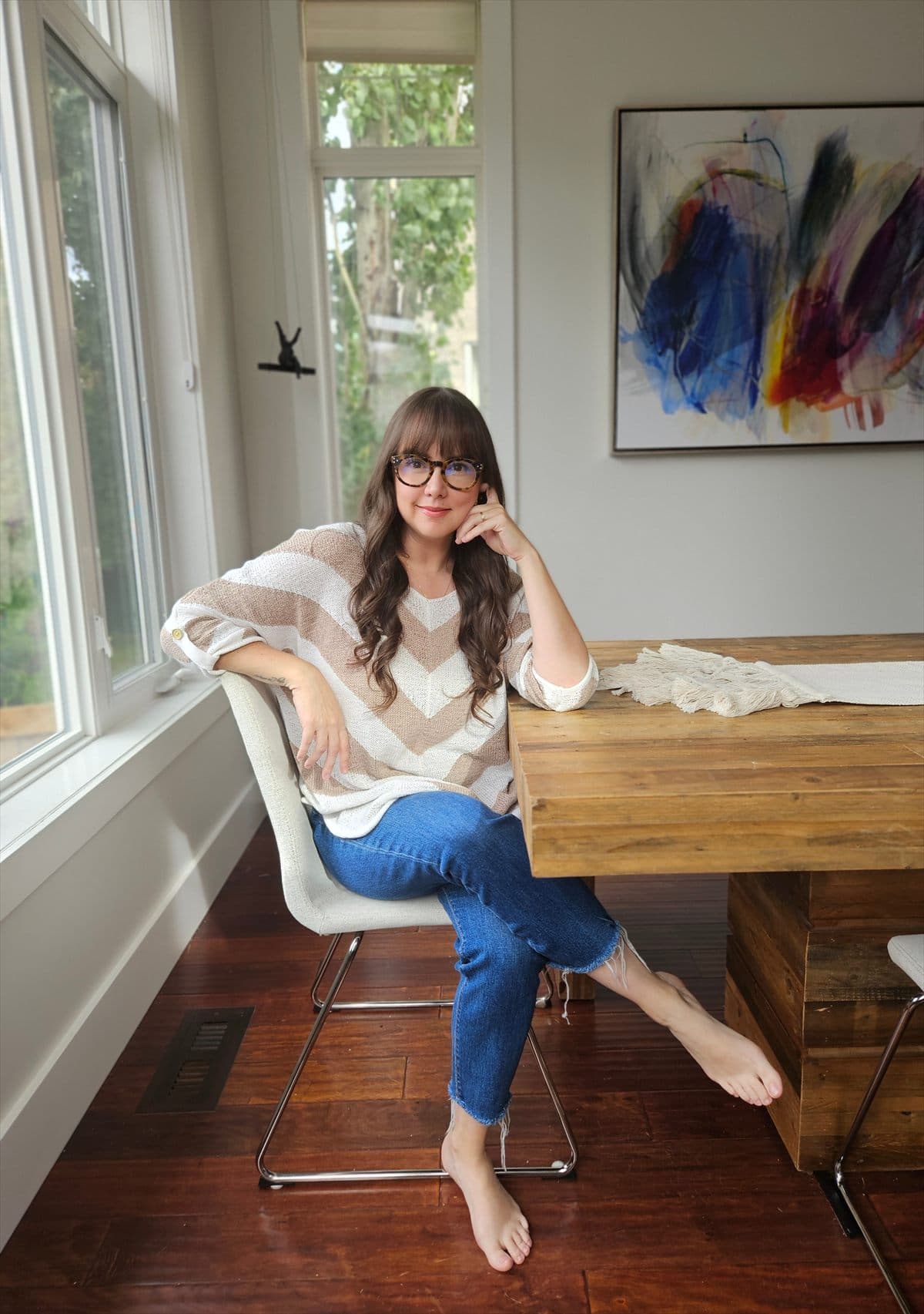 Vero seated by a window, at home.